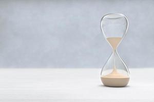 Hourglass on Wooden floor with copy space, sandglass photo