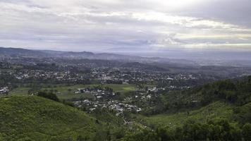 Aerial view of tea plantation in Kemuning, Indonesia with Lawu mountain background photo