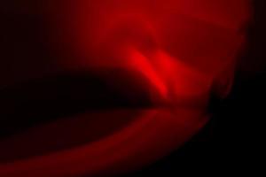 Red abstract glare on a black background. photo