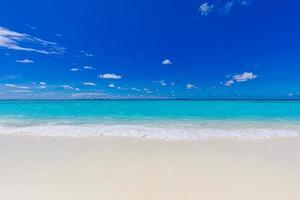 Tropical beach panorama as summer landscape and white sand and calm sea for beach banner. Perfect beach scene vacation and summer holiday concept. Island nature, shore coast, seaside photo