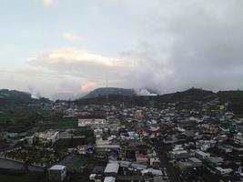 Aerial view of Dieng village at Wonosobo with mountain around it photo