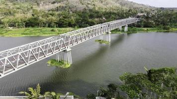 Aerial of long steel bridge in Kretek village, Yogyakarta, Indonesia photo