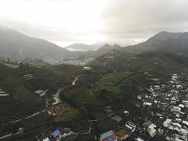 Aerial view of Dieng village at Wonosobo with mountain around it photo
