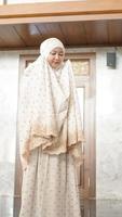 Asian Muslim women perform the obligatory prayers in the mosque photo