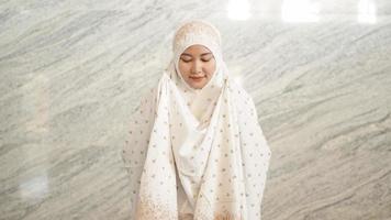 Asian Muslim women praying at the mosque photo