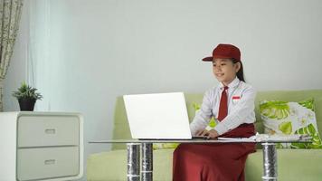 asian elementary school girl learning to use laptop at home photo