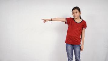 asian little girl pointing isolated on white background photo