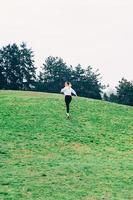 young woman, running up the hill, romantic or freedom concept photo