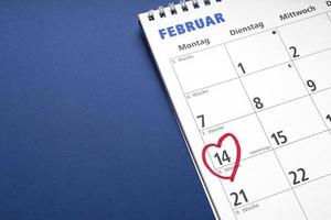 red heart drawn around february 14 as Valentinstag or Valentine's day symbol on german calendar photo