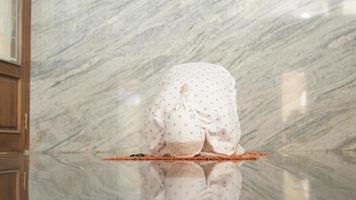 Asian Muslim women pray prostration in the mosque photo