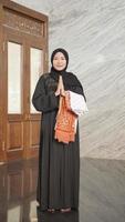 Muslim woman gesturing sorry for worship in the mosque photo