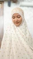 Asian Muslim women perform the obligatory prayers in the mosque photo