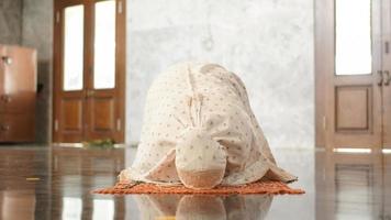 Asian Muslim women pray prostration in the mosque photo