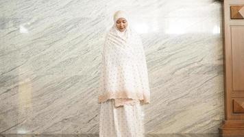 Asian Muslim women praying at the mosque photo