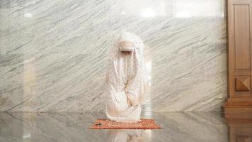 Asian Muslim women praying at the mosque photo