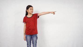 asian little girl pointing isolated on white background photo