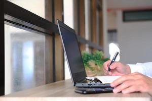 Close-up hand of a woman freelancing working, trading, and typing on a laptop with a graph at home, stock market and finance cryptocurrency trade concept. photo