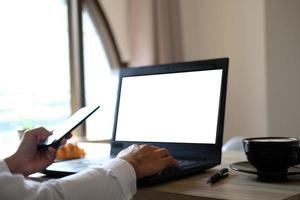 Close-up hand of a woman freelancing working, trading, and typing on a laptop with a graph at home, stock market and finance cryptocurrency trade concept. photo