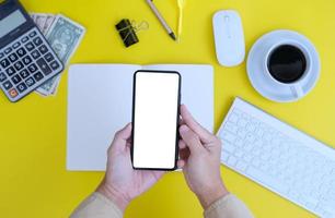 Blank notebook with pen is placed on an office desk table with computer tools and a range of materials. finance and banking background, flat lay, top view photo