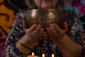 close-up of Tibetan singing bowl held by woman's hands photo