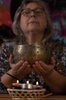 close-up of Tibetan singing bowl held by woman's hands photo