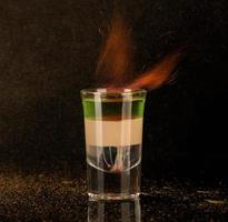 shot glass with alcohol on a dark background photo