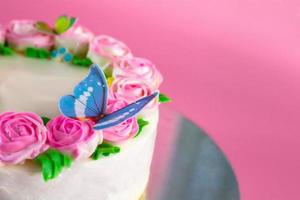 Butter cream of Pink Roses decorated oo vanilla pond cake on pink background with copy space served in Birthday Party and wedding. Delicious sweet bakery for someone you love. photo