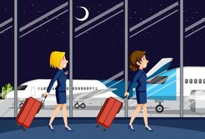 Flight attendants walking in airport terminal vector