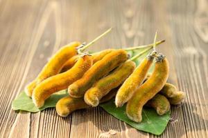 Bunch of Mucuna pruriens on wooden table photo
