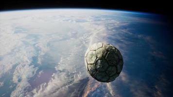 old soccer ball in space on Earth orbit video