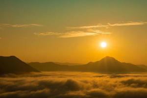 Sea Fog and Golden sunrise covers the area on the top of hill Doi Phu Thok, Chiang Khan, Loei, Thailand with background of sunrise on winter. photo