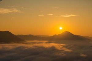 Sea Fog and Golden sunrise covers the area on the top of hill Doi Phu Thok, Chiang Khan, Loei, Thailand with background of sunrise on winter. photo