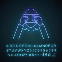 VR cardboard neon light icon. Virtual reality platform. Hand made VR headset with smartphone. Virtual reality player. Glowing sign with alphabet, numbers and symbols. Vector isolated illustration