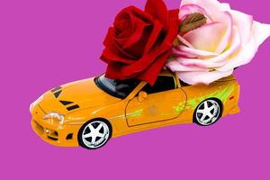 toy car with roses on lilac background photo