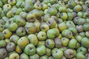 Green apple fruits on a market shelf photo