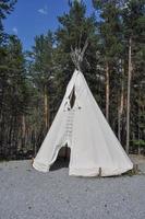 A fabric tent shelter for outdoor camping in a pine tree forest photo