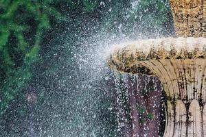 Water fountain in park. Splashing streams of in stream pouring from . on surface lake. in summer . photo