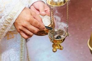 priest singing in a christian sermon censer church rite foog photo