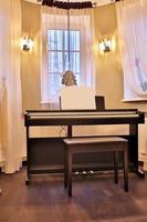 Old piano in the ancient house. The room is aged style. Interior of the home. photo