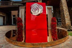 Arch for wedding ceremony a is decorated with red roses flowers and greens, greenery. wedding decor. photo