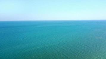 Aerial view of calm sea blue water and sky without clouds. place for text photo