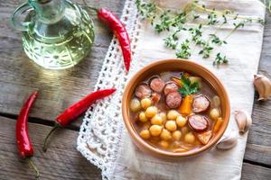 Soup with chickpeas and smoked sausage photo