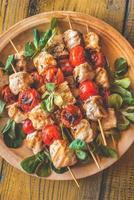 Grilled chicken skewers on the plate photo