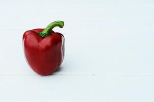 Red chili pepper on white wooden table bacgrounds photo