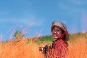 Portrait of Woman Walking in Red Meadow in Summer photo