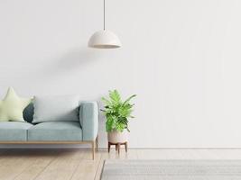 Empty living room with blue sofa, plants and table on empty white wall background. photo