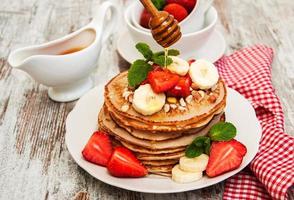 Pancakes with strawberries and bananas photo