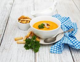 Pumpkin soup with fresh pumpkins photo