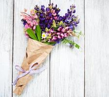 Lupine flowers on a  table photo