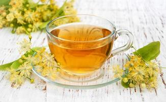 cup of herbal tea with linden flowers photo